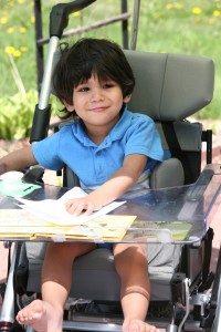 Disabled child in medical stroller